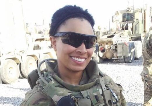 A woman in military uniform smiling for the camera.